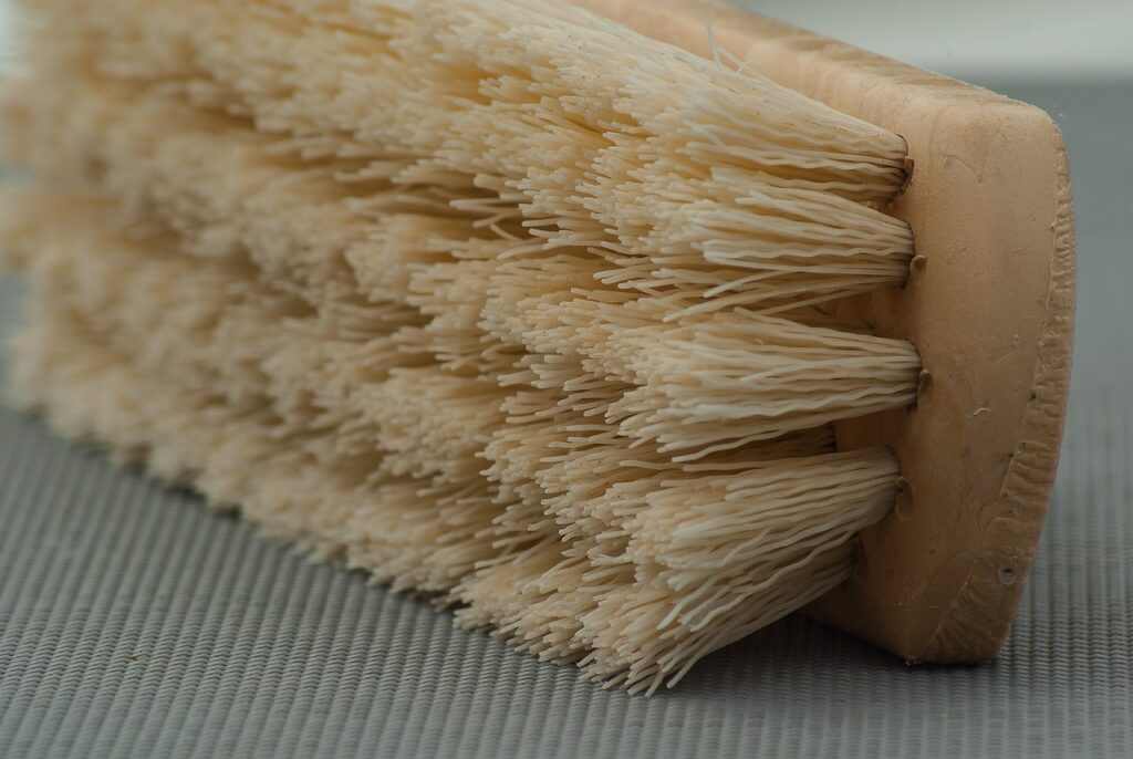 close-up of a cleaning brush with firm bristles, ideal for scrubbing tough stains on various surfaces